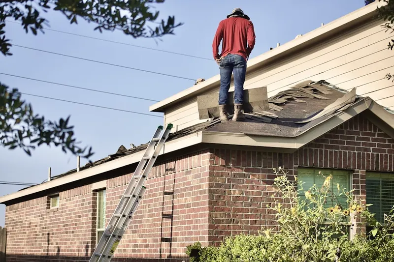 Professional roofer working on a residential roof in Lyndale